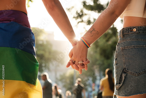 Anonymous lesbian couple holding hands at pride photo