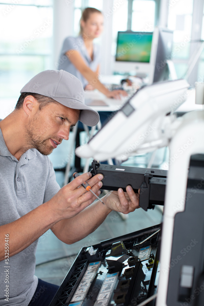 service agent is maintaining an office printer service agent is maintaining an office printer