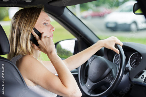 woman talking on cellphone while driving © auremar