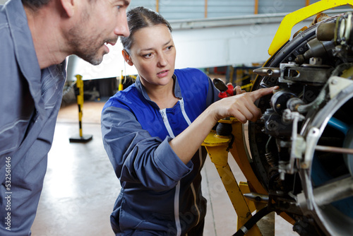 two engineers fixing an engine