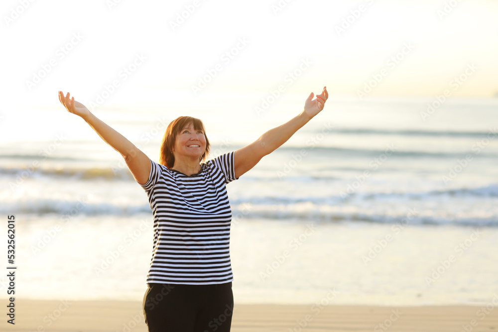 Yoga and meditation of mature woman practicing breath exercises on the sea beach on sunrise in the morning. Body mind and spirit, mindfulness concept. Enlightenment and healthy lifestyle. Yoga and meditation of mature woman practicing breath exercises on the sea beach on sunrise in the morning. Body mind and spirit, mindfulness concept. Enlightenment and healthy lifestyle.