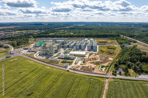 aerial view on rows of agro silos granary elevator with seeds cleaning line on agro-processing manufacturing plant for processing drying cleaning and storage of agricultural products