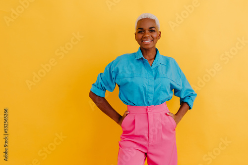 Delighted black woman in trendy outfit