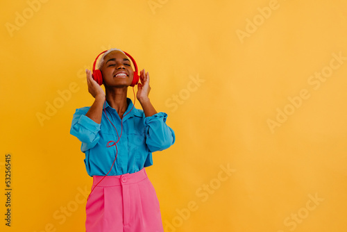 Smiling black woman listening to song in headset photo