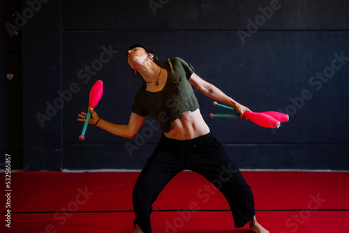 Artistic female juggler training photo