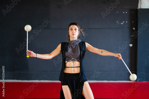 Active woman dancing with poi balls photo