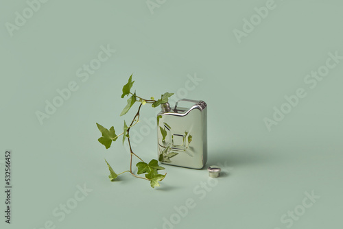 Steel canister with green plant. photo