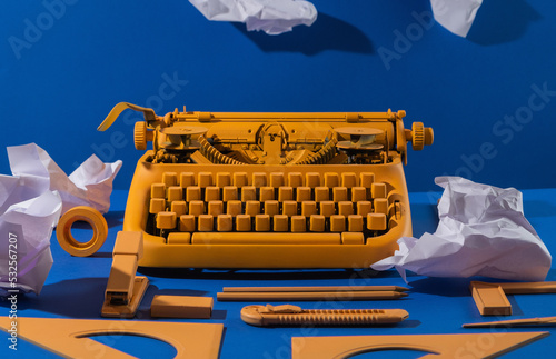 Yellow typewritter, office supplies,  papers. photo