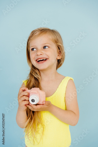 Smiling kid in swimsuit with camera photo