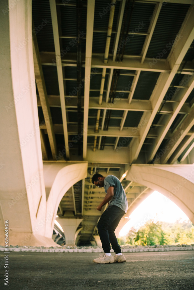 A Dancer Poses Beneath A Bridge In The City A Dancer Poses Beneath A Bridge In The City