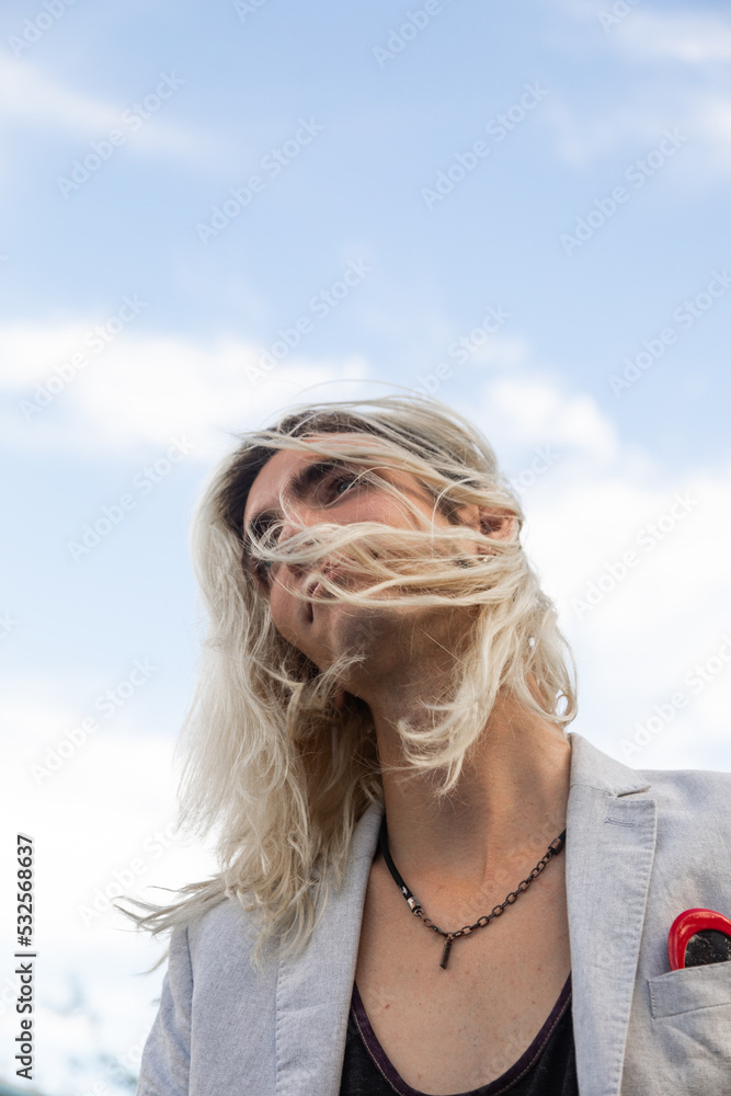 Man with long hair with sky in background Man with long hair with sky in background