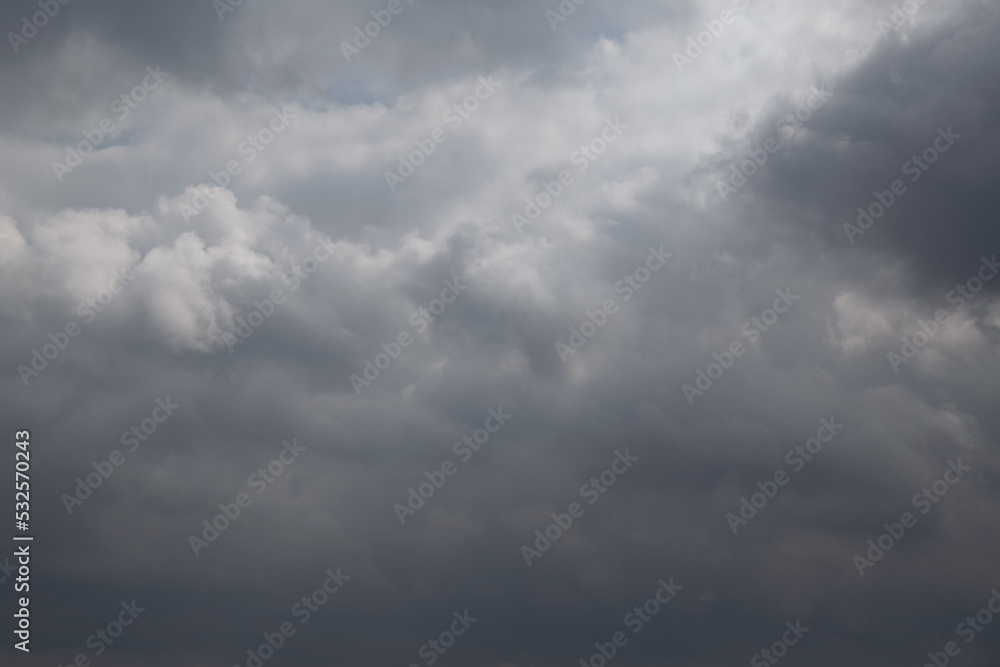 Blue sky in the gap between dark rain clouds Blue sky in the gap between dark rain clouds