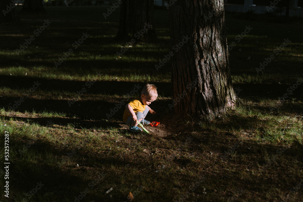 The kid is playing in a clearing. The kid is playing in a clearing.