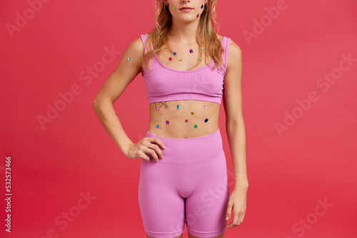 Lady with colorful gems on body in studio photo