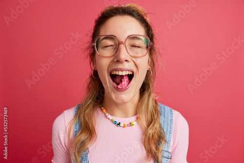 Teenage lady chewing bubble gum in studio photo