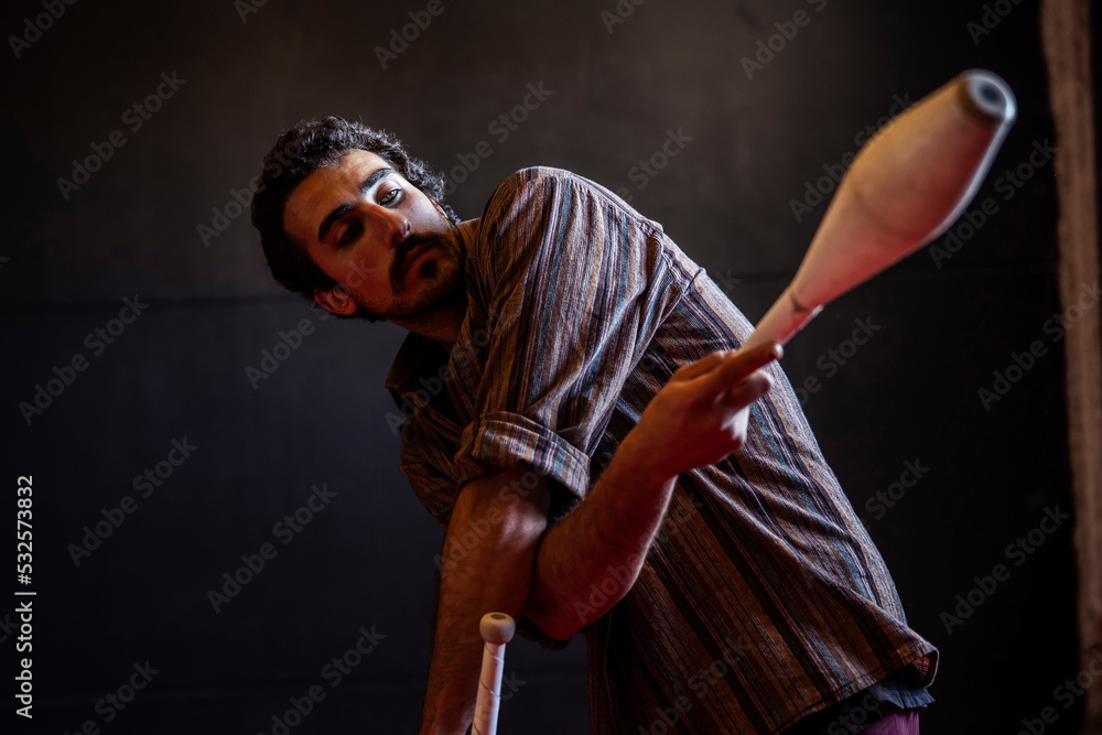 © Albert Martinez/Stocksy - Talented juggler using clubs during rehearsal