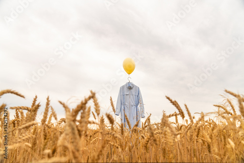 Balloon with clothes at the hanger like a symbol of human soul photo