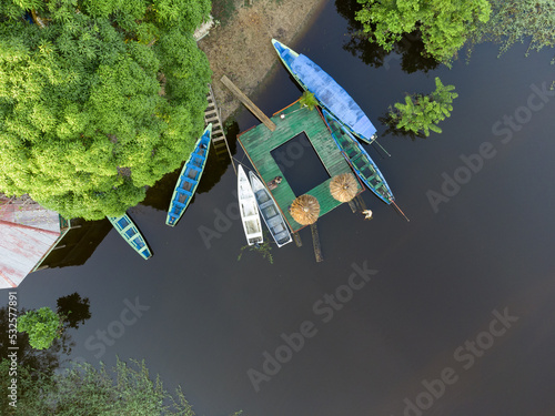 Cuadro en lienzo Aerial top view of a small wooden pier and some conoes in the amazon river in th