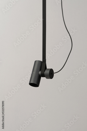 Hanging dark rounded lamp with strap and cable photo