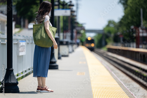 Woman waiting at train station photo