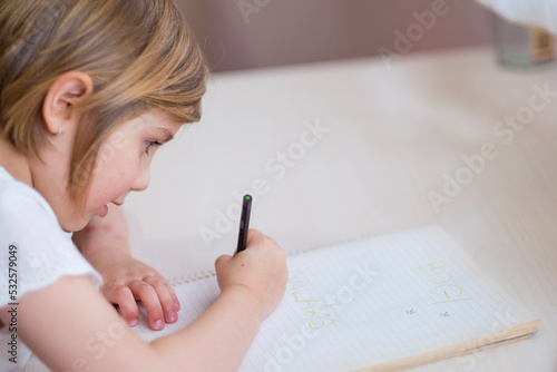 The child learns to write photo