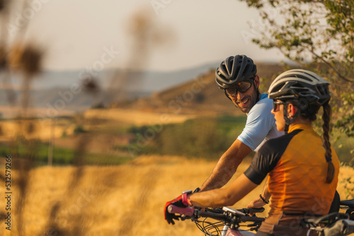 Two mountain bikers between wheat fields photo