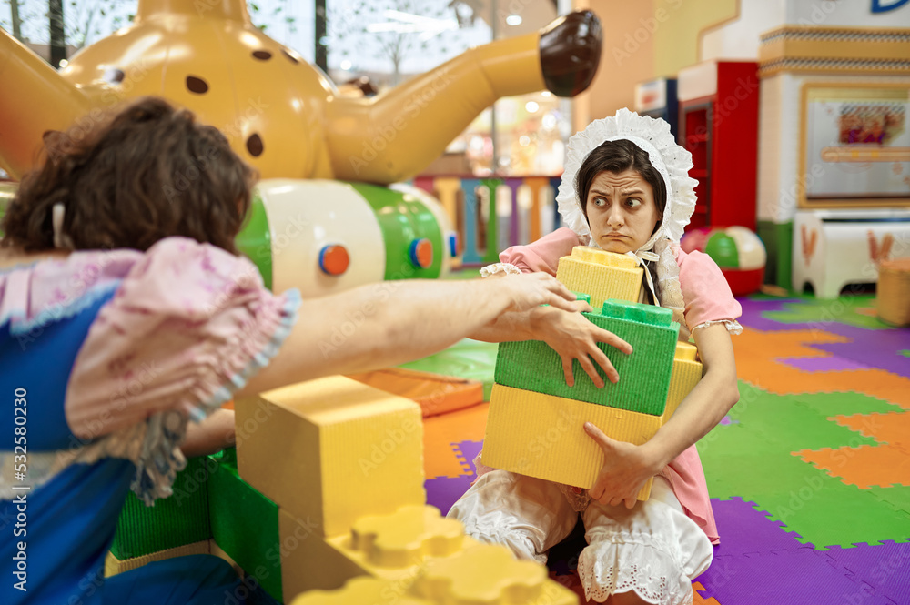 Obraz premium Funny man and woman like baby playing soft building blocks
