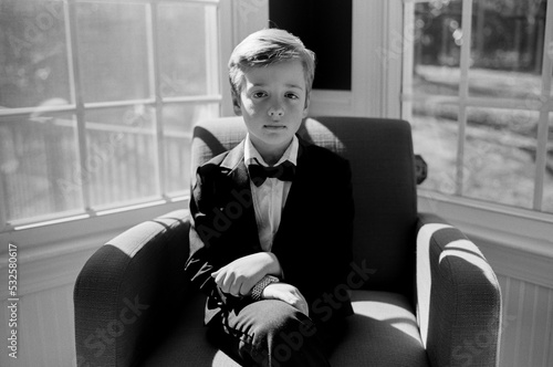 Adorable young boy in a tuxedo photo