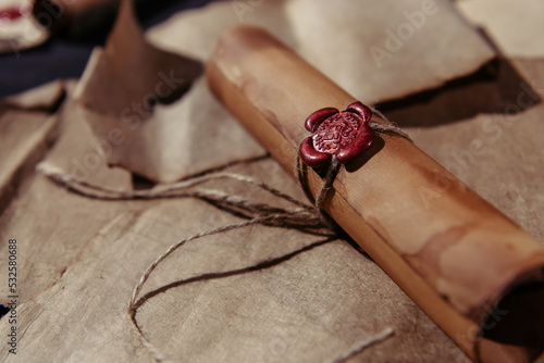 close up view of medieval manuscript with rope and wax seal on parchment surface.