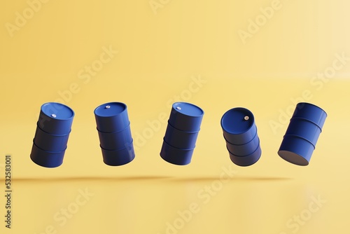 Group of blue oil drums isolated on yellow background photo