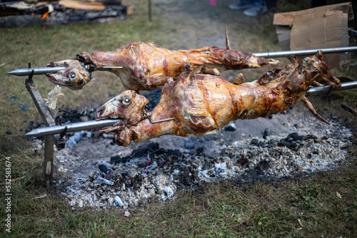 Whole lamb lambs roasted on a barbecue spit. Outdoor Barbecue grill a classic traditional open bbq pit. Steaks and meat cooked on a wood fire grill.