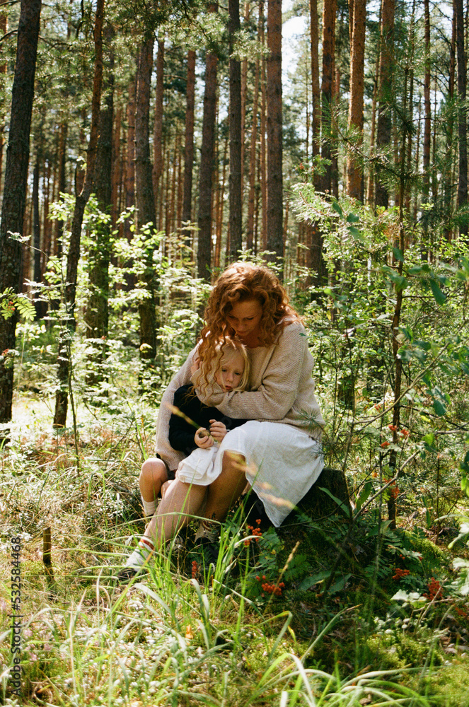 Mother hugging son in the forest Mother hugging son in the forest