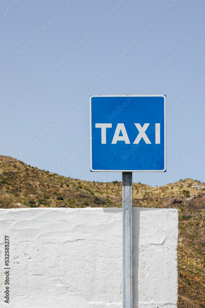 Old taxi sign on road