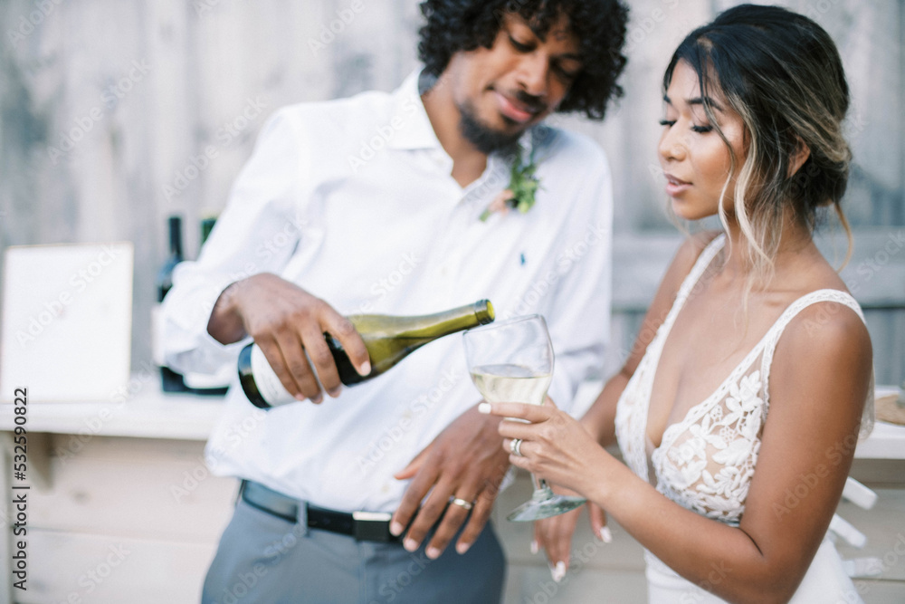 husband and wife having a drink at their wedding celebration husband and wife having a drink at their wedding celebration