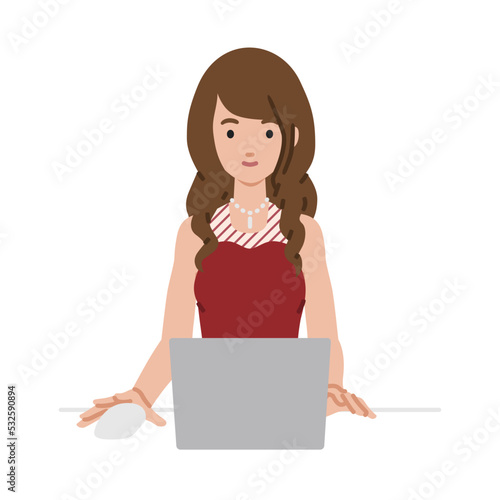 デスクで座ってPCを使っているドレスの女性