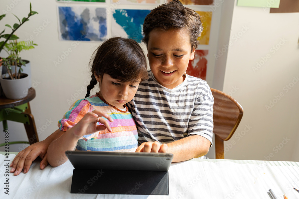 Bbrother helping his little sister with homework Bbrother helping his little sister with homework