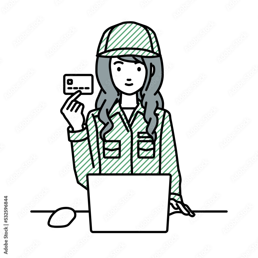 デスクで座ってPCを使いながらクレジットカードを手に持っている作業員の女性