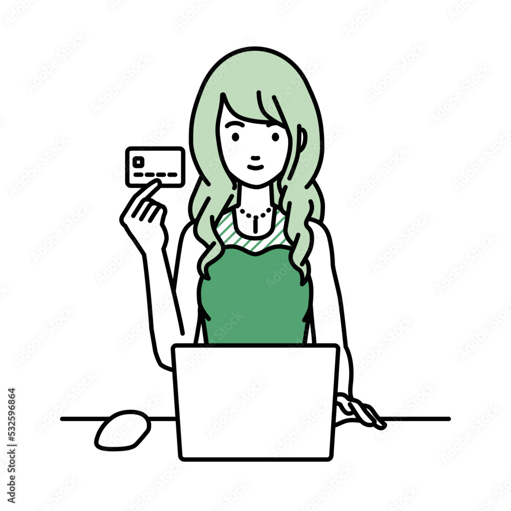 デスクで座ってPCを使いながらクレジットカードを手に持っているドレスの女性 デスクで座ってPCを使いながらクレジットカードを手に持っているドレスの女性
