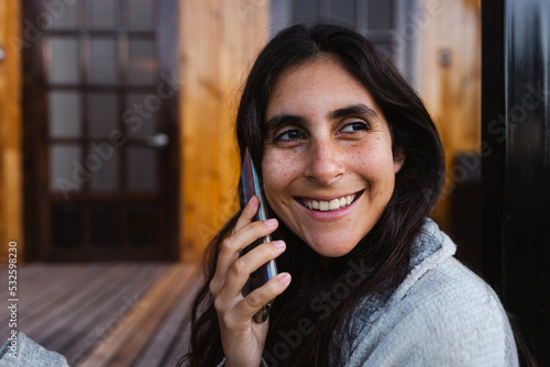 portrait of happy woman on the phone photo