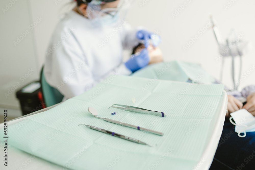 Dentist working on a patient in dentist clinic Dentist working on a patient in dentist clinic