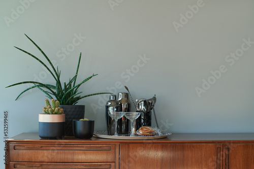 Mid century furniture with cocktail tray and houseplants photo