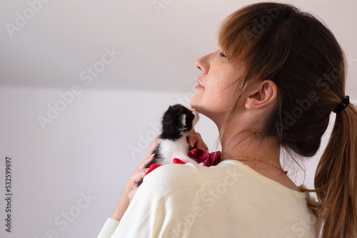 Female holding Newborn baby kittens adopted from the street