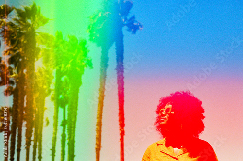 Rainbow palm tree portrait of woman photo