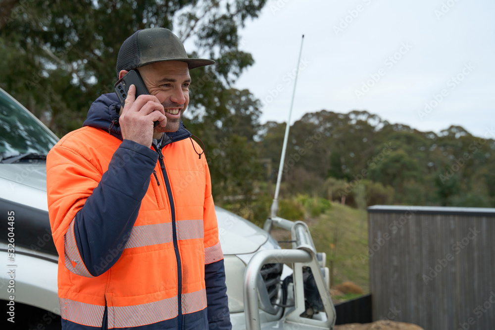 Smiling workman on phone call Smiling workman on phone call