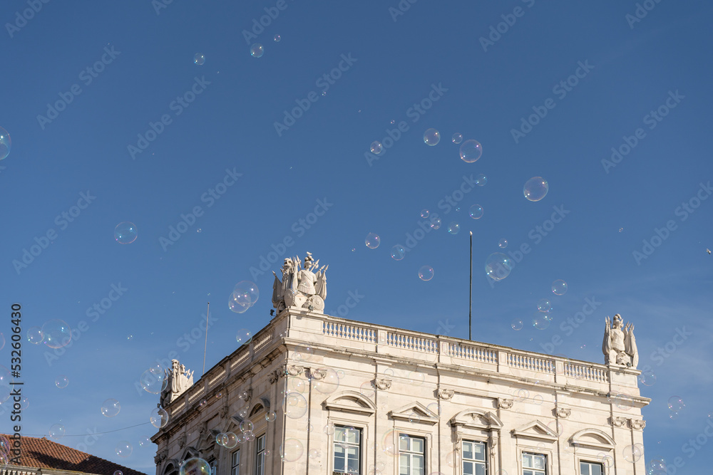 soap bubbles in the air with historical structures in the background