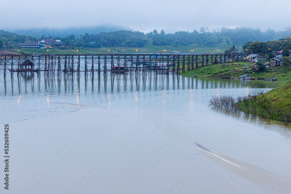 View of nature on the old wooden bridge in the morning in Thailand.