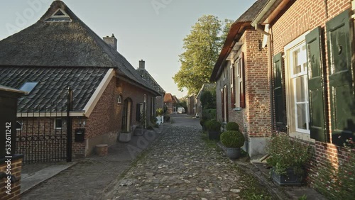 POV of a person walking on an empty street in one of the smallest Dutch towns, Bronkhorst, The Netherlands. photo