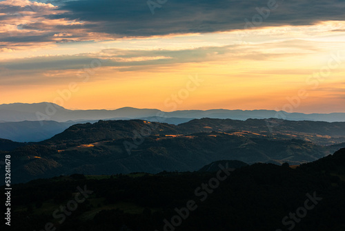 Sunset Over Hills And Mountains. photo