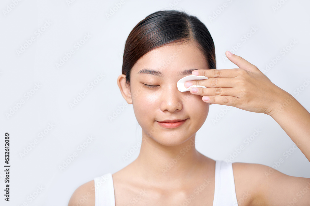 Beautiful young asian woman using cotton pads for removing Beautiful young asian woman using cotton pads for removing