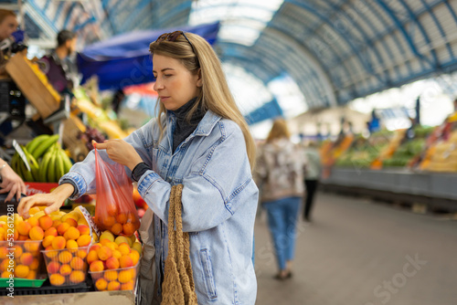 Woman buying fresh apricots